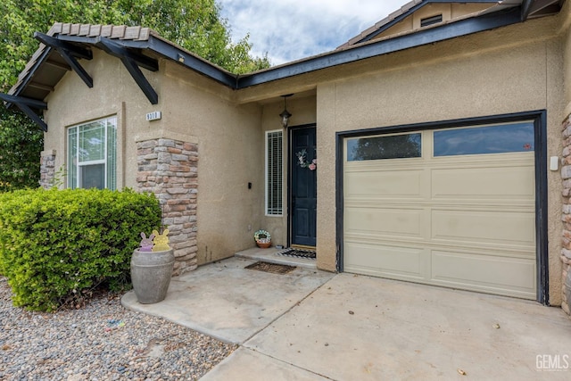 9310 Via Catania, Bakersfield, CA 93312 - entrance to property with stucco siding, an attached garage, and stone siding