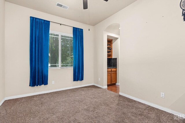 9310 Via Catania, Bakersfield, CA 93312 - spare room featuring carpet flooring, ceiling fan, visible vents, baseboards, and arched walkways