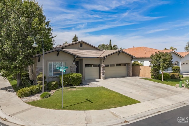 9310 Via Catania, Bakersfield, CA 93312 - ranch-style home featuring a front yard, stucco siding, driveway, stone siding, and an attached garage
