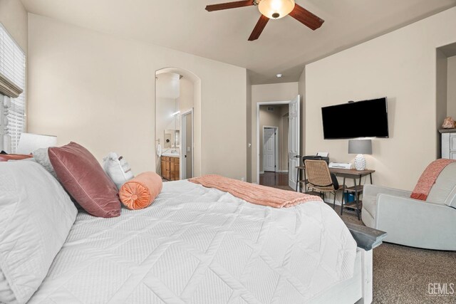 9310 Via Catania, Bakersfield, CA 93312 - carpeted bedroom with arched walkways, ceiling fan, and connected bathroom