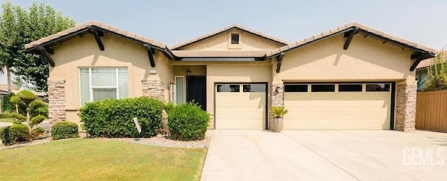 9310 Via Catania, Bakersfield, CA 93312 - view of front facade featuring stucco siding, concrete driveway, a front yard, and a garage