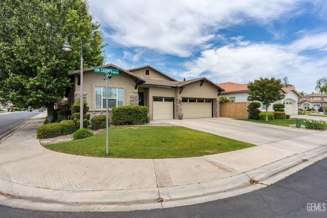 9310 Via Catania, Bakersfield, CA 93312 - view of front of home with stucco siding, fence, a front yard, concrete driveway, and an attached garage