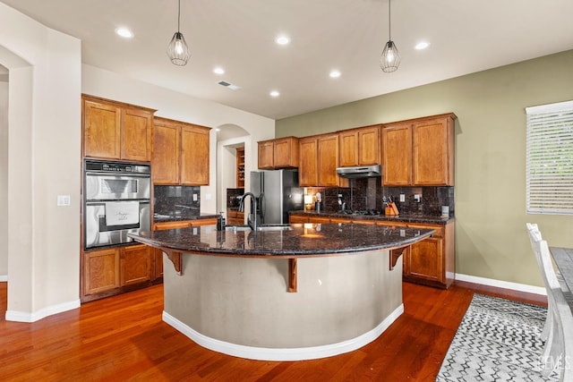 9310 Via Catania, Bakersfield, CA 93312 - kitchen with a sink, refrigerator with ice dispenser, and brown cabinetry