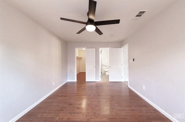 2800 S Real Rd, Bakersfield, CA 93309 - unfurnished bedroom with a walk in closet, baseboards, wood finished floors, ensuite bath, and a closet
