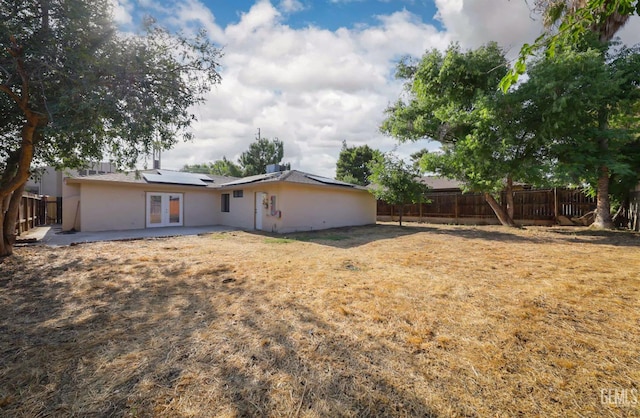 2800 S Real Rd, Bakersfield, CA 93309 - back of property featuring a patio area, french doors, a fenced backyard, and roof mounted solar panels