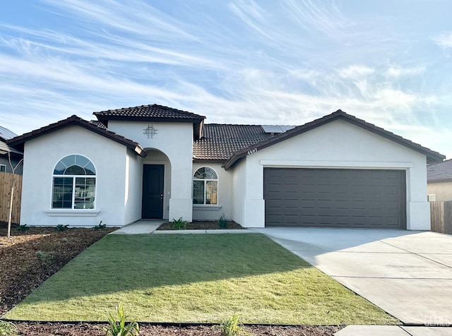 view of front of home with a garage and a front lawn