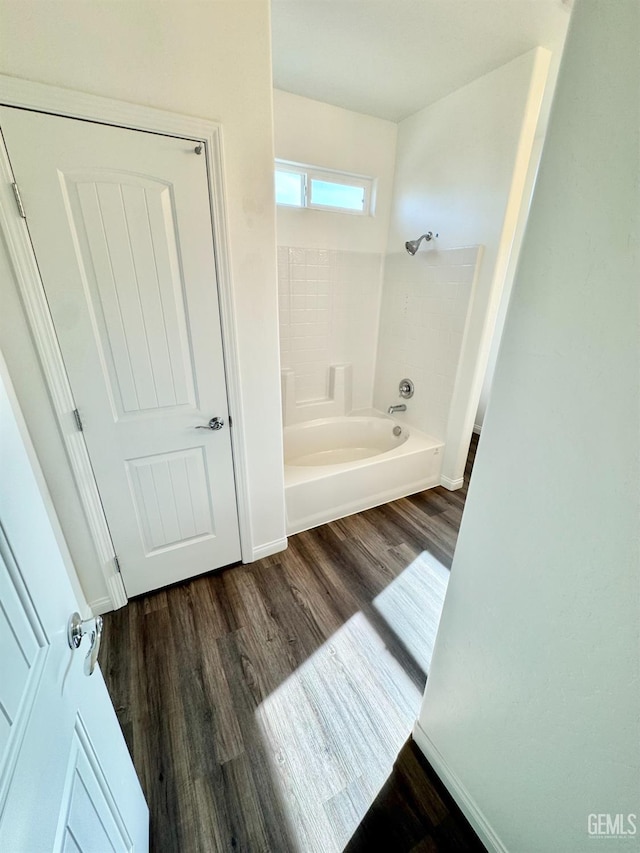 bathroom with wood-type flooring and bathing tub / shower combination