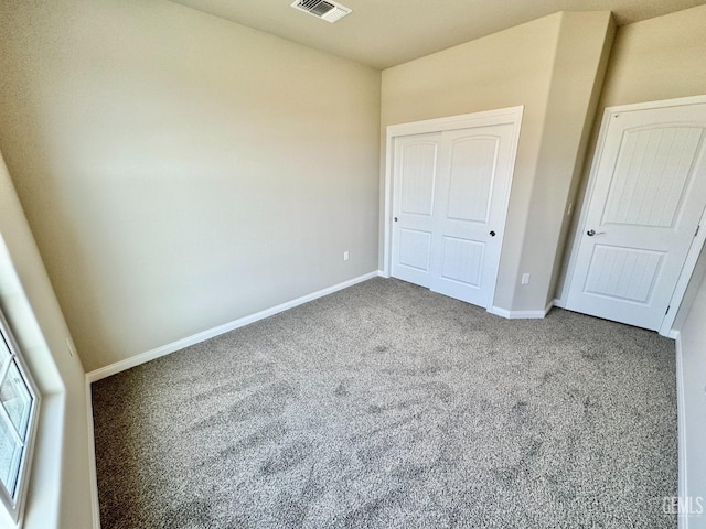 unfurnished bedroom with carpet flooring and a closet