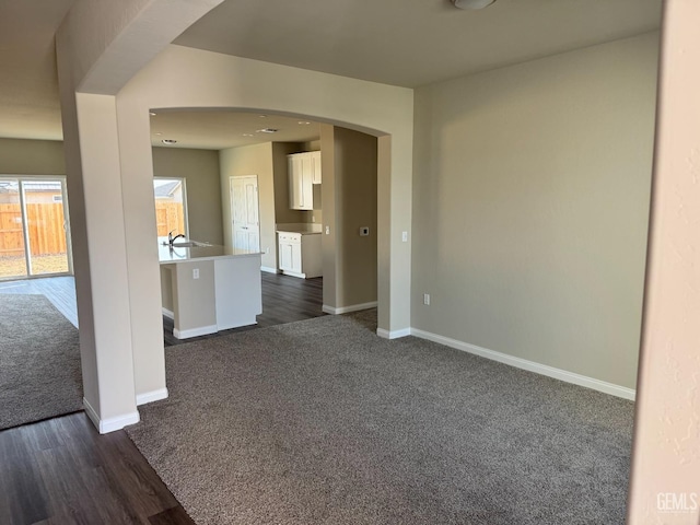 empty room with dark colored carpet and sink