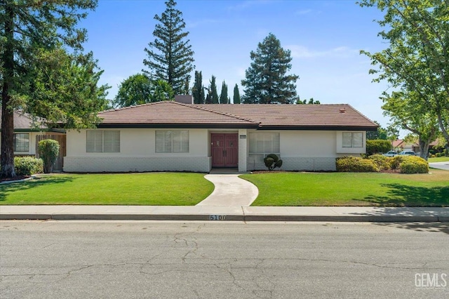 5100 Ruth Ct, Bakersfield, CA 93308 - ranch-style home with brick siding, a front yard, and a tiled roof