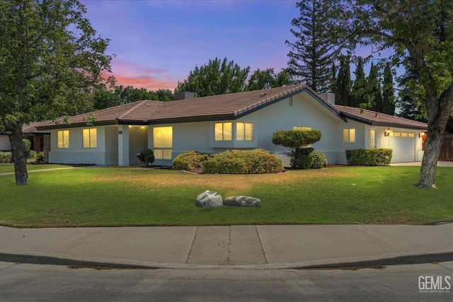 5100 Ruth Ct, Bakersfield, CA 93308 - ranch-style house featuring an attached garage, a yard, and stucco siding