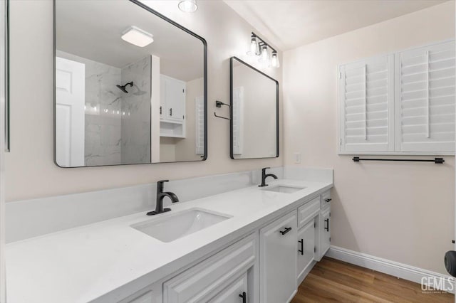 5100 Ruth Ct, Bakersfield, CA 93308 - bathroom with a marble finish shower, double vanity, and wood finished floors