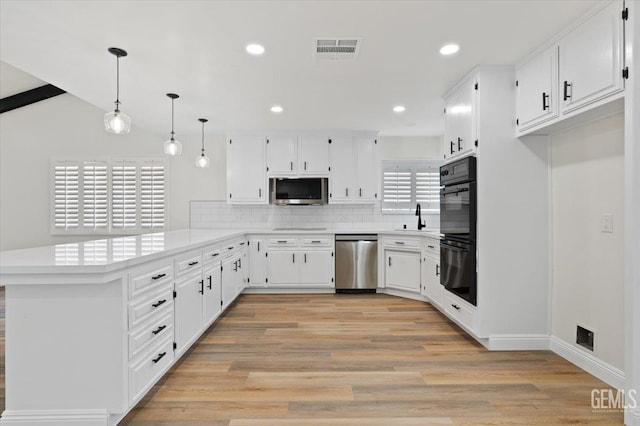 5100 Ruth Ct, Bakersfield, CA 93308 - kitchen featuring a peninsula, backsplash, light countertops, dishwasher, and white cabinetry