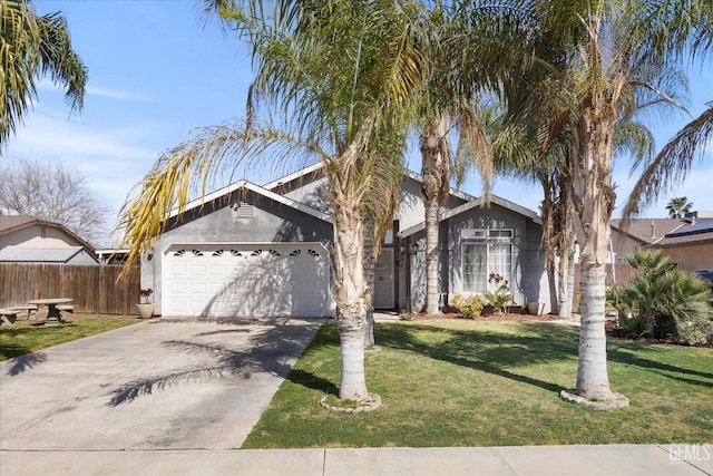 view of front of home with fence, an attached garage, stucco siding, concrete driveway, and a front lawn