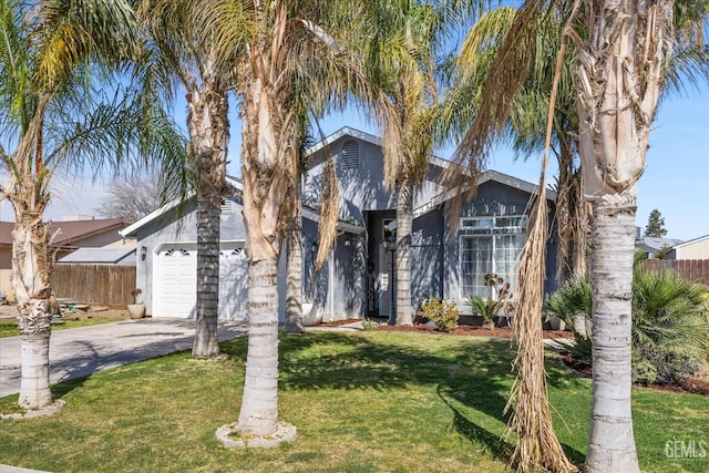 view of front of property with a front yard, fence, a garage, and driveway