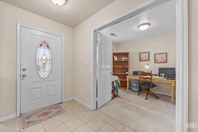 entrance foyer featuring light colored carpet