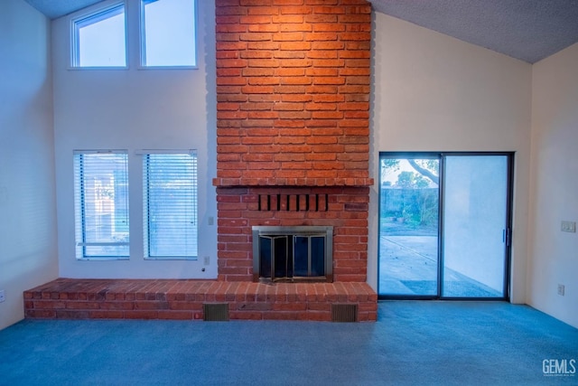 unfurnished living room featuring carpet, a healthy amount of sunlight, visible vents, and a fireplace