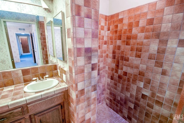 bathroom with visible vents, backsplash, and vanity