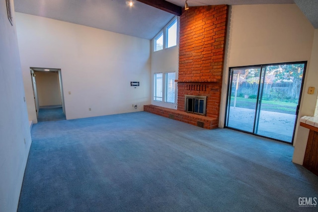 unfurnished living room featuring a fireplace, high vaulted ceiling, beamed ceiling, and carpet flooring