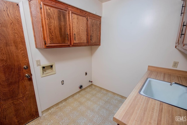 laundry area featuring light floors, hookup for a washing machine, cabinet space, hookup for an electric dryer, and a sink