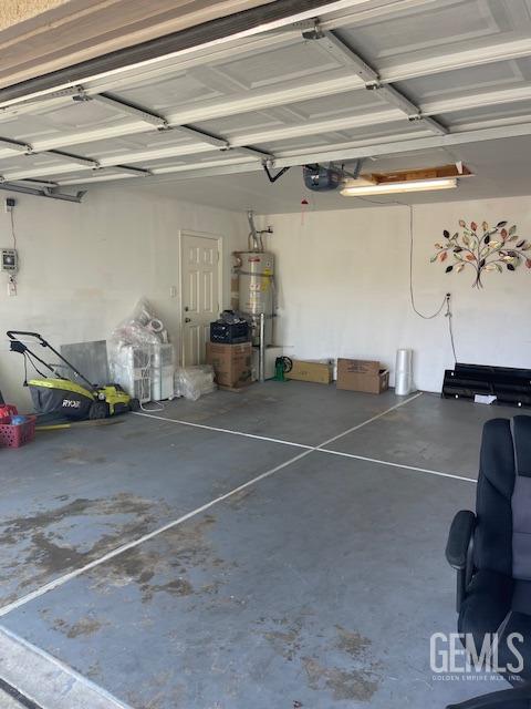 garage featuring secured water heater and a garage door opener