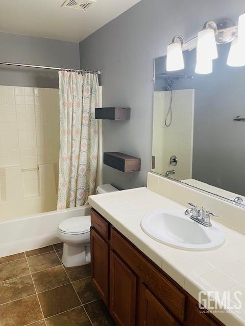 full bath with vanity, toilet, shower / tub combo, and visible vents