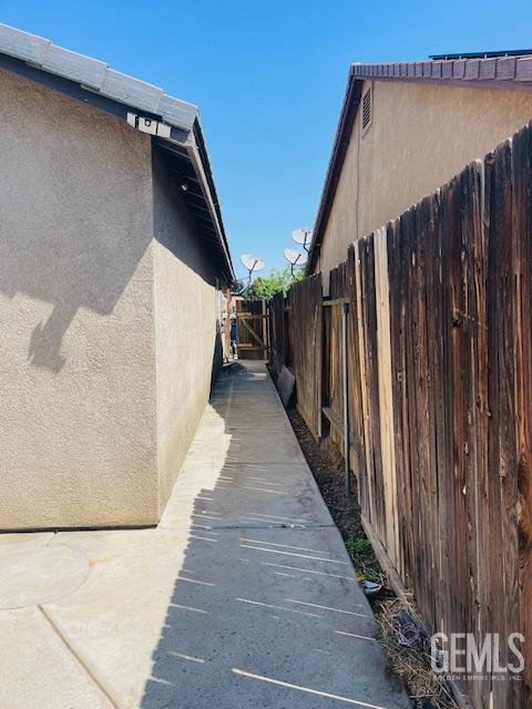 view of property exterior featuring fence and stucco siding