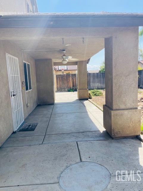 view of patio / terrace featuring fence and a ceiling fan