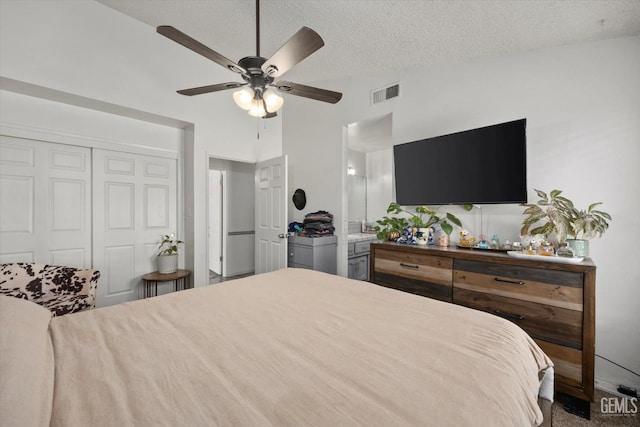 6305 Wolfe Creek Dr, Bakersfield, CA 93306 - carpeted bedroom featuring a closet, vaulted ceiling, a textured ceiling, and a ceiling fan