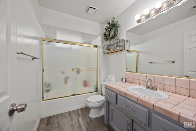 6305 Wolfe Creek Dr, Bakersfield, CA 93306 - bathroom with vanity, wood finished floors, tasteful backsplash, and shower / bath combination with glass door