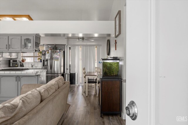 6305 Wolfe Creek Dr, Bakersfield, CA 93306 - living area with dark wood-style floors and a ceiling fan