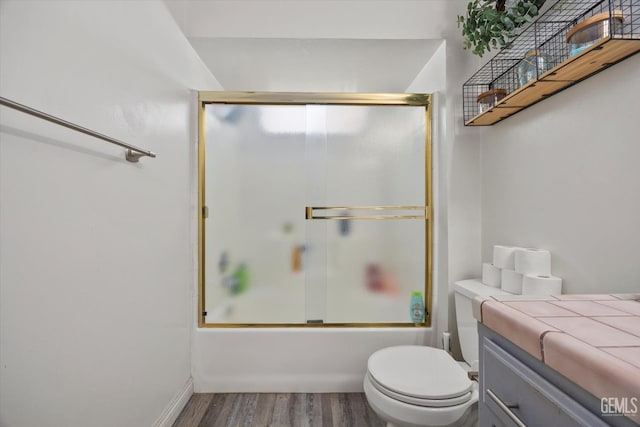 6305 Wolfe Creek Dr, Bakersfield, CA 93306 - bathroom featuring wood finished floors, vanity, and shower / bath combination with glass door