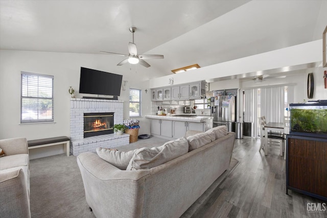 6305 Wolfe Creek Dr, Bakersfield, CA 93306 - living area with a ceiling fan, vaulted ceiling, a fireplace, and wood finished floors
