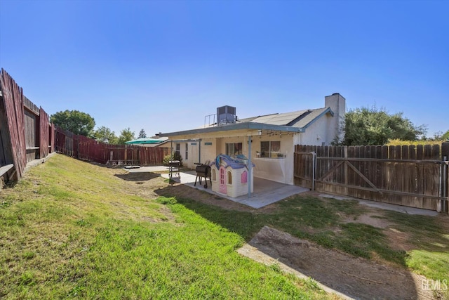 6305 Wolfe Creek Dr, Bakersfield, CA 93306 - back of house with a patio, a fenced backyard, a chimney, and stucco siding