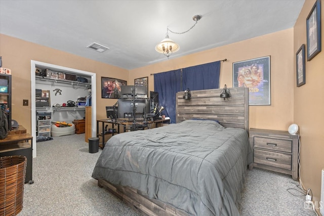 bedroom with a closet, visible vents, and carpet flooring