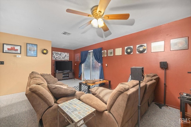 living area featuring light carpet, visible vents, and a ceiling fan