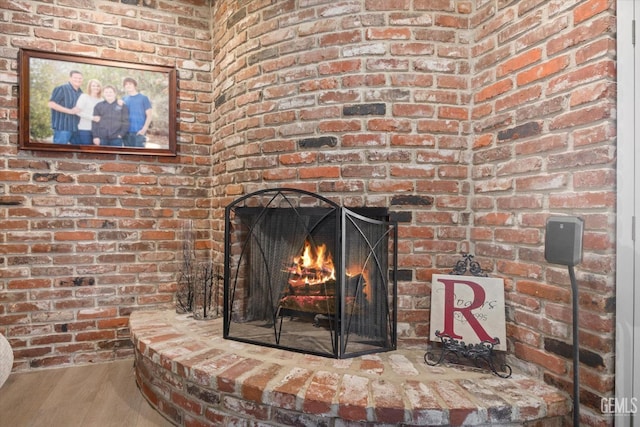 room details with a fireplace and wood finished floors