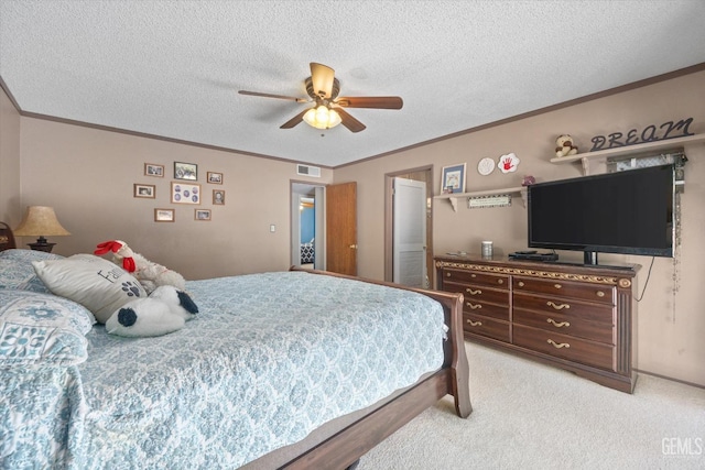 bedroom featuring visible vents, crown molding, light carpet, and a textured ceiling