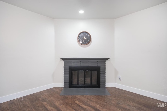 interior details featuring recessed lighting, a brick fireplace, wood finished floors, and baseboards