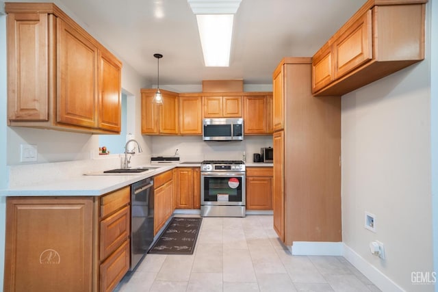 kitchen with stainless steel appliances, a sink, baseboards, hanging light fixtures, and light countertops