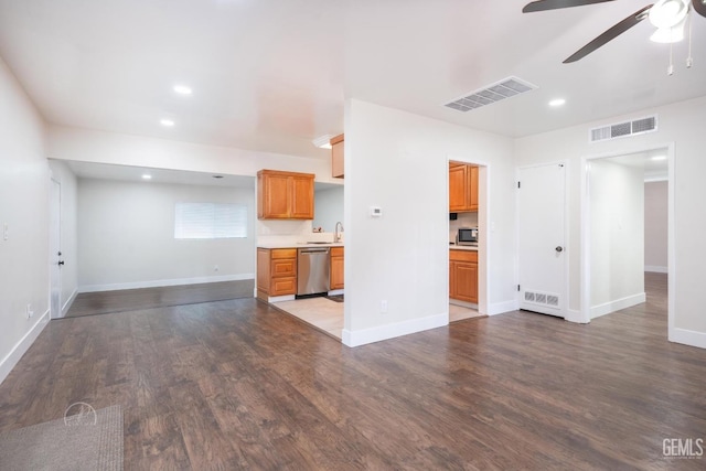 kitchen with stainless steel appliances, light countertops, visible vents, and wood finished floors