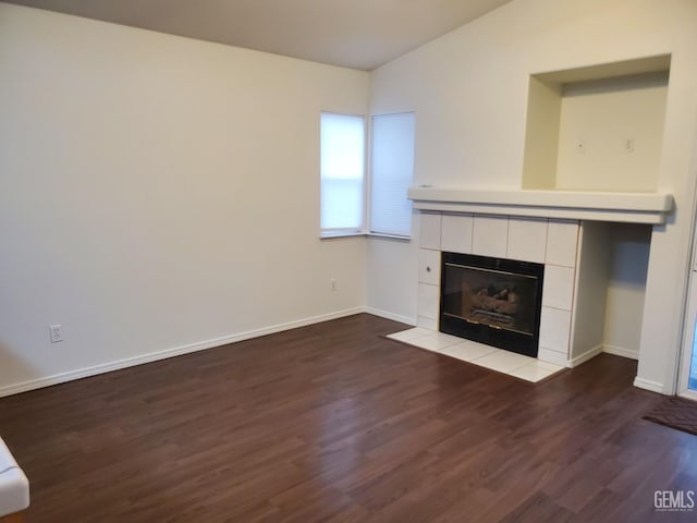 unfurnished living room with hardwood / wood-style flooring and a tile fireplace