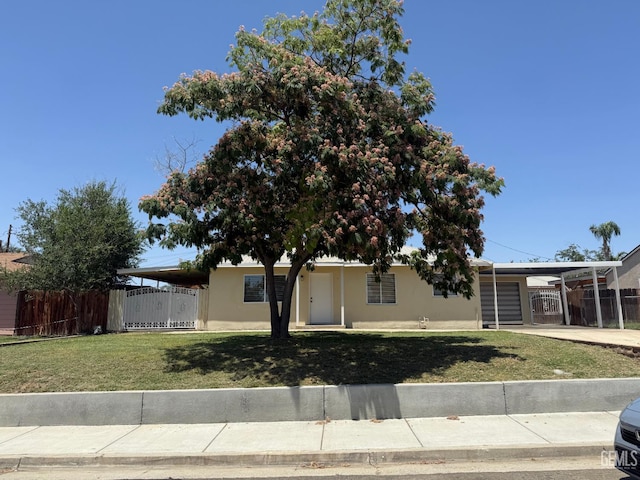 1708 Bower St, Bakersfield, CA 93305 - view of front of house with stucco siding, a carport, and driveway