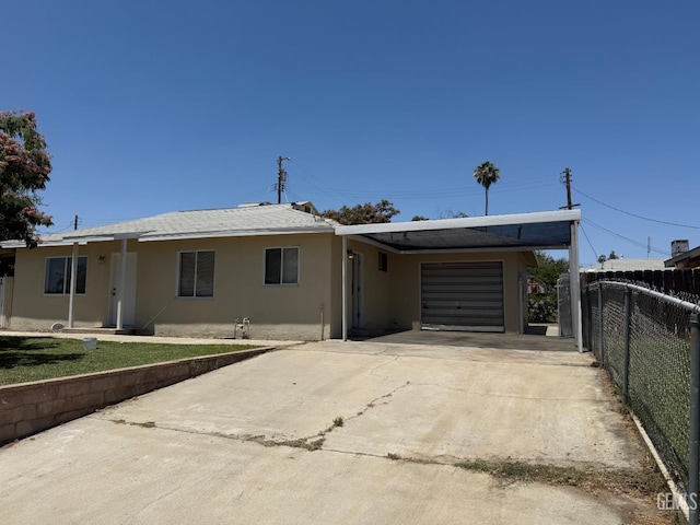 1708 Bower St, Bakersfield, CA 93305 - ranch-style home with a garage, stucco siding, and driveway