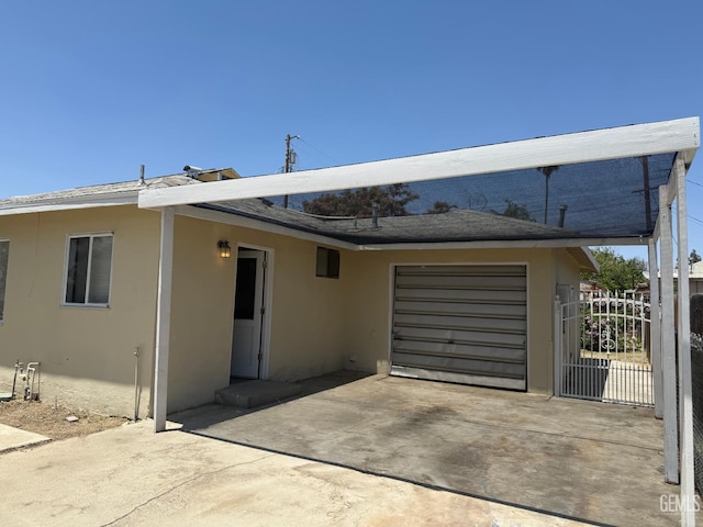 1708 Bower St, Bakersfield, CA 93305 - rear view of house featuring stucco siding, driveway, and an attached garage