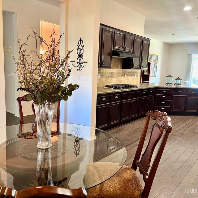 9909 Stockholm Pl, Bakersfield, CA 93306 - kitchen with backsplash, dark brown cabinets, and stainless steel gas stovetop