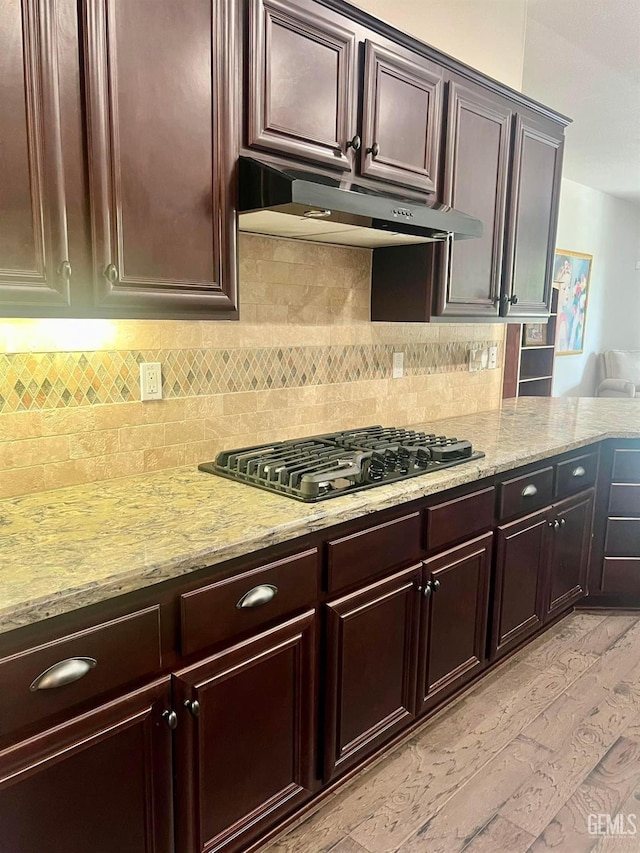 9909 Stockholm Pl, Bakersfield, CA 93306 - kitchen featuring tasteful backsplash, light stone countertops, black gas cooktop, and dark brown cabinetry