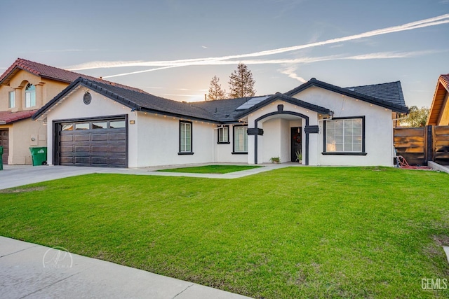 view of front of property with a lawn and a garage