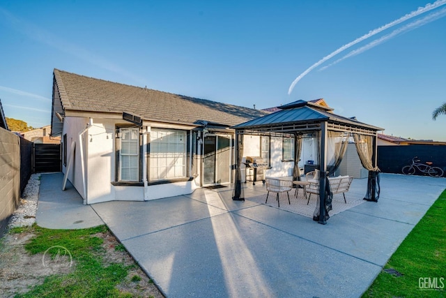 back of house with a gazebo and a patio area