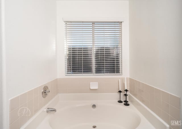 bathroom with a tub to relax in